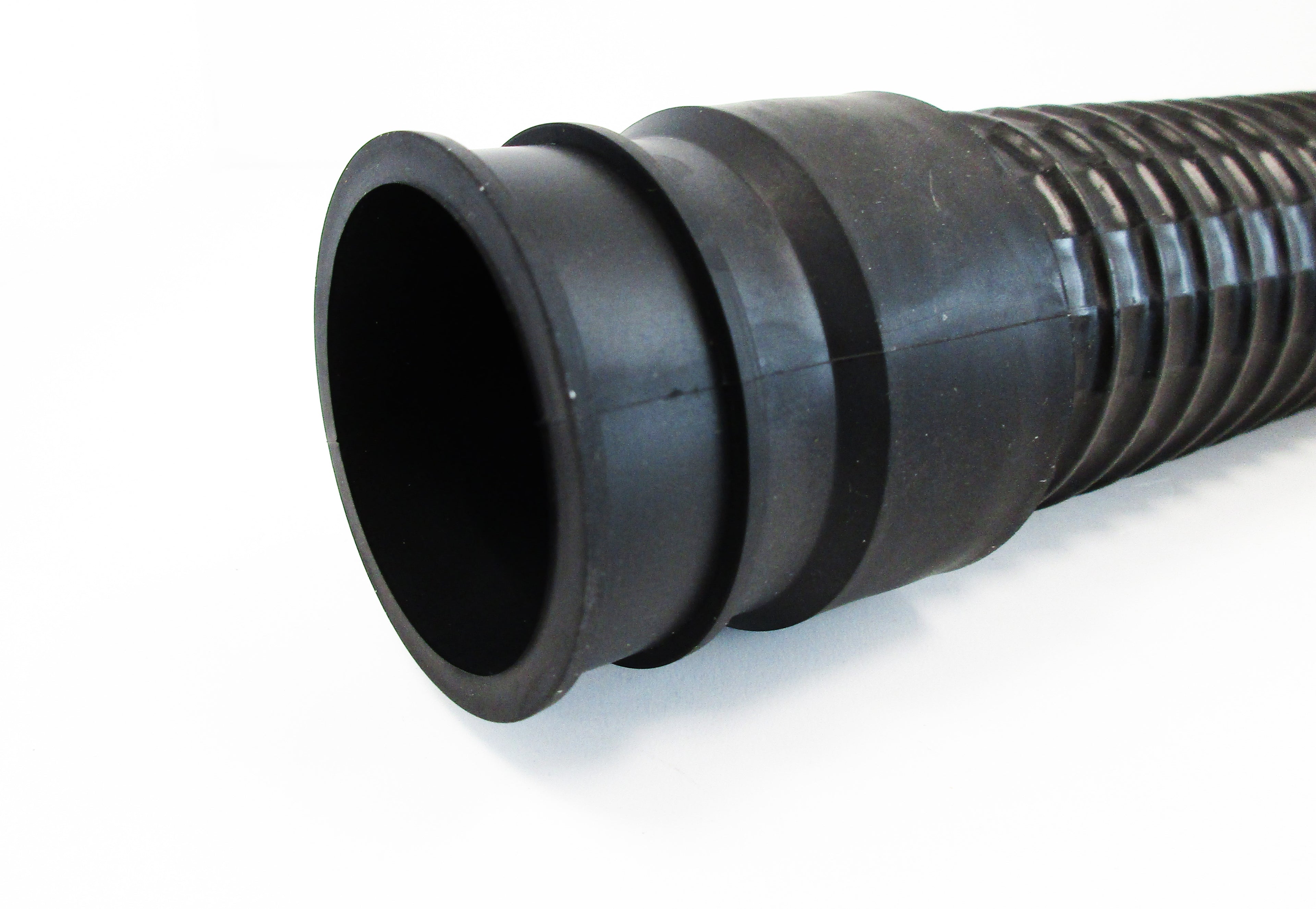 A close-up of a black corrugated flexible hose, with connection cuffs on a white background.