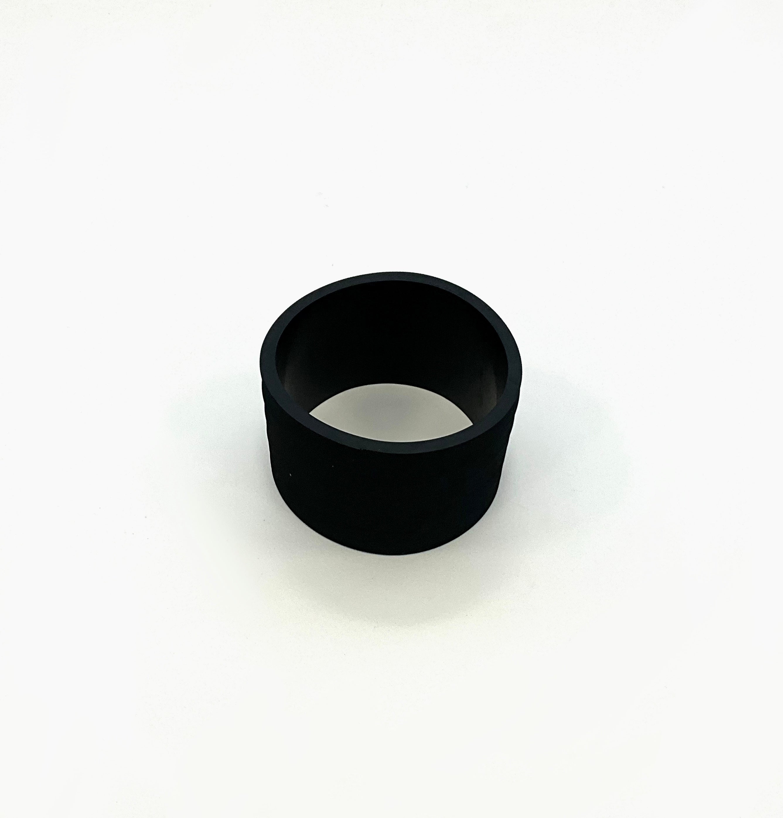 A black cylindrical ring-shaped rubber straight, photographed on a white background.